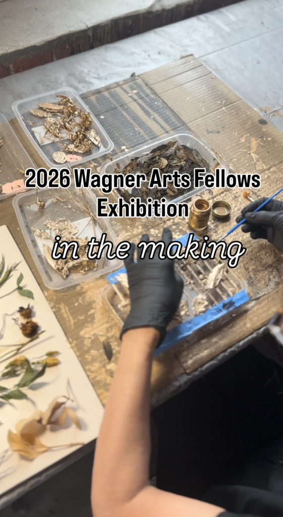 A person wearing black gloves works with dried plants and art supplies on a wooden table. Text reads 2026 Wagner Arts Fellows Exhibition in the making..